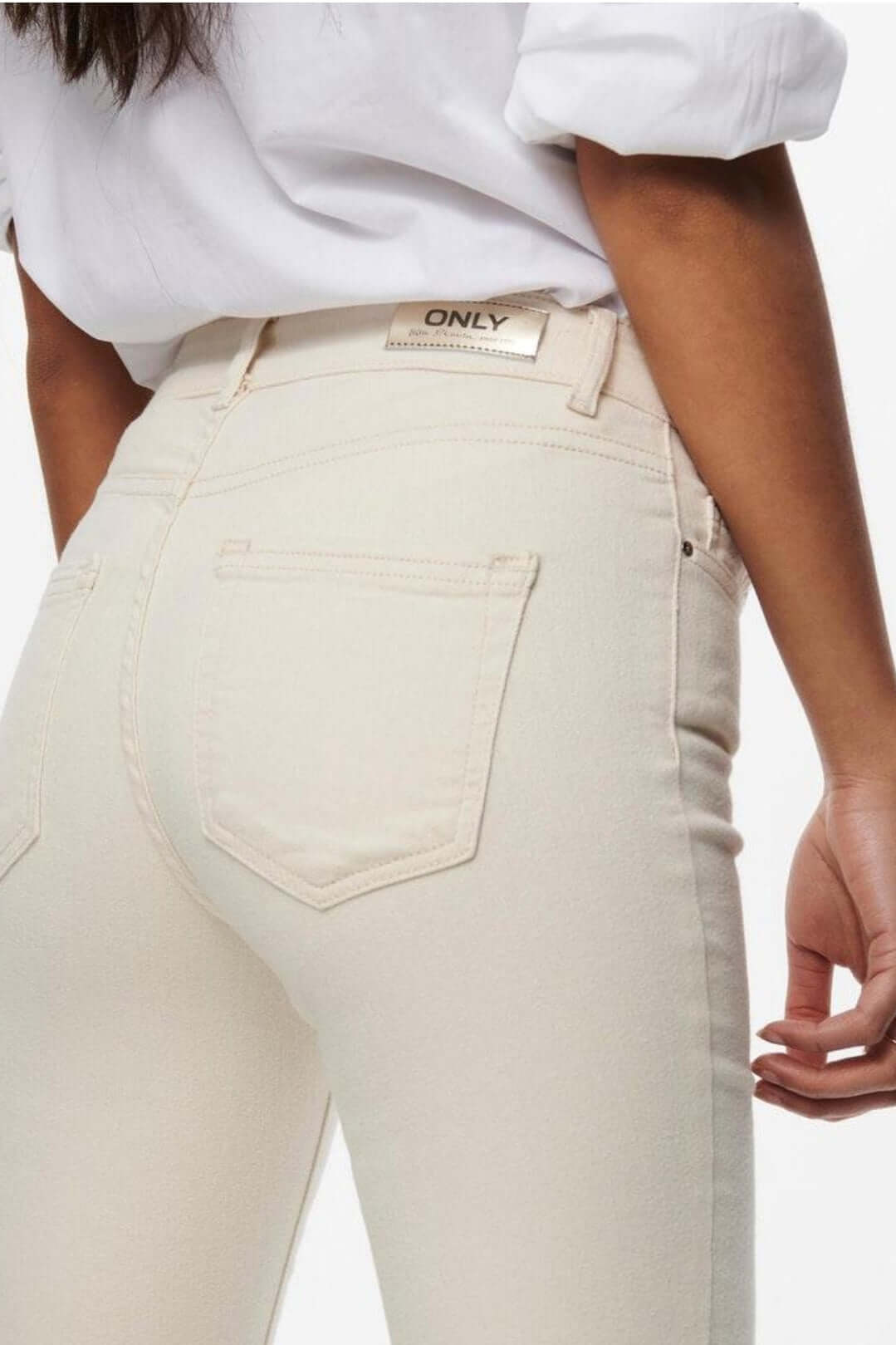Back view of Only Dames BLUSH Mid Flared jeans in Ecru, showcasing stylish design and branding.